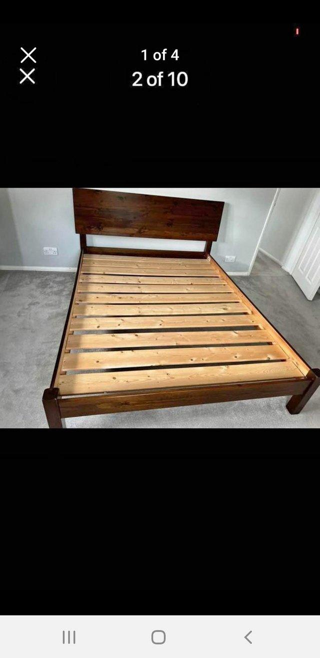 Preview of the first image of Warren Evans dark wooden king size bed frame.