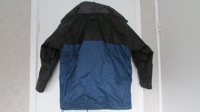 Preview of the first image of Blue and black fleece lined wipe clean coat 9/10yrs.