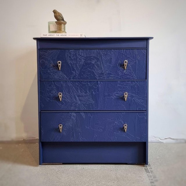 Preview of the first image of Mid Century chest of drawers in dark blue with parrot detail.