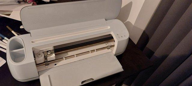 Preview of the first image of Cricut maker 3 with tools and vinyls.