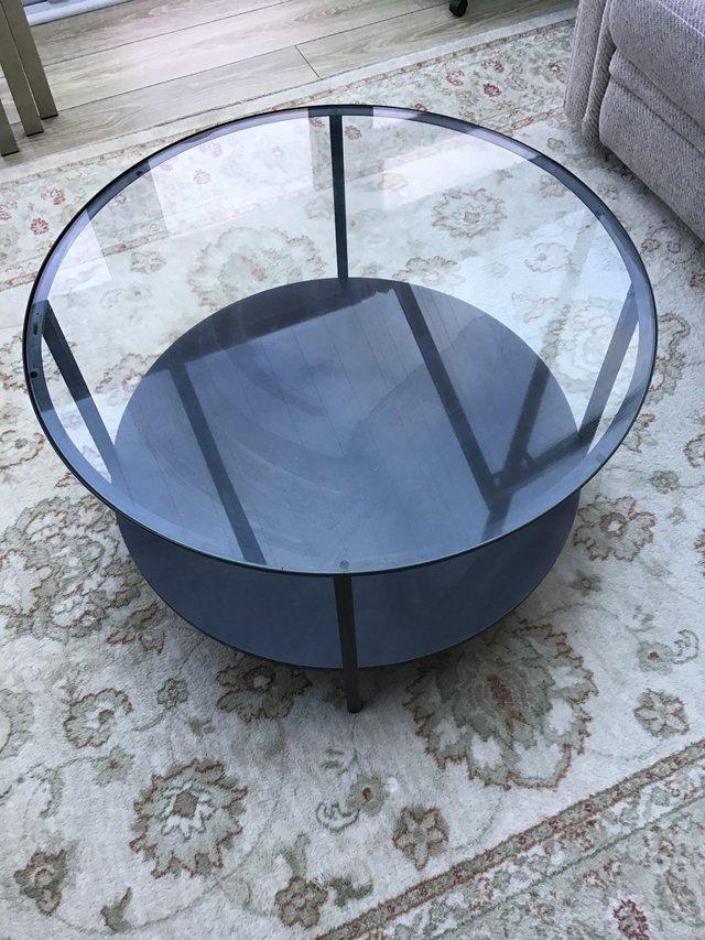 Preview of the first image of Circular Glass top table with metal legs.