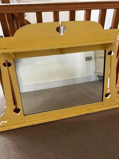 Preview of the first image of Vintage solid wood mirror with shelf, painted yellow.