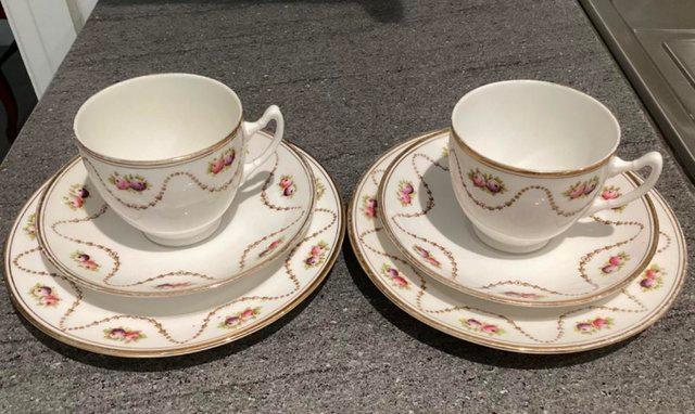 Preview of the first image of Royal Albert Crown China tea cups, saucers and plates.