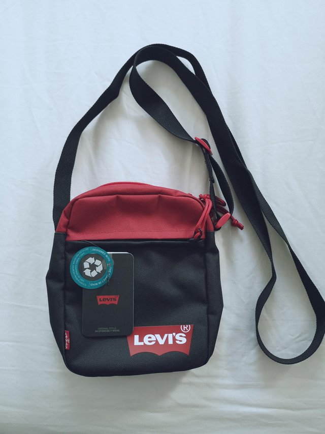 Preview of the first image of Mens Levi's 'Mini Crossbody' Solid Red Batwing Bag.