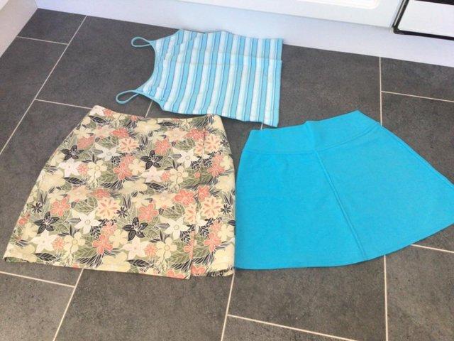 Preview of the first image of Lovely selection of tops beach wear dresses and skirts.