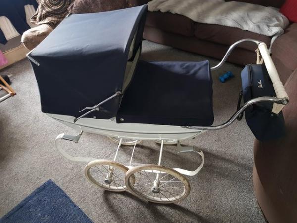 Image 1 of Silver Cross dolls pram and matching nappy bag.