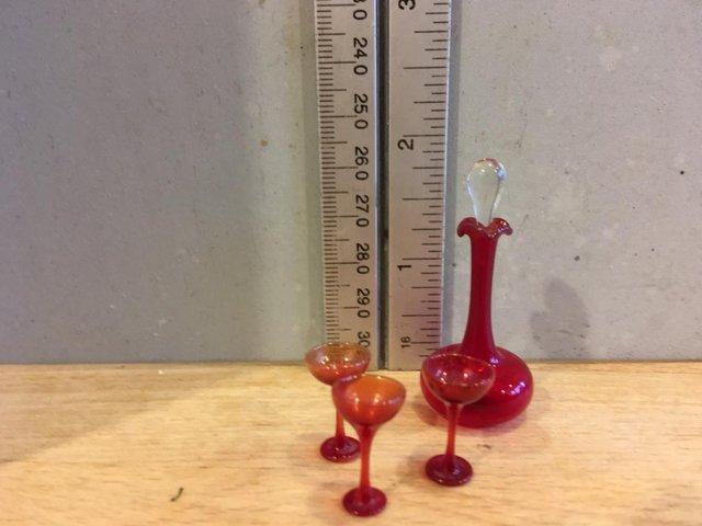 Preview of the first image of Vintage Miniature red glass decanter and glasses.