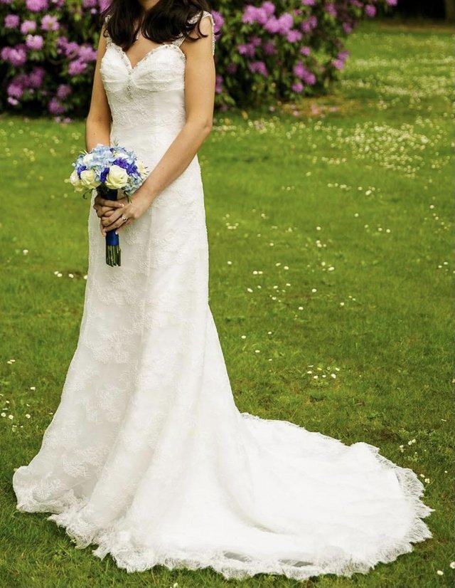 Preview of the first image of Ivory lace wedding dress with low back and beading detail.