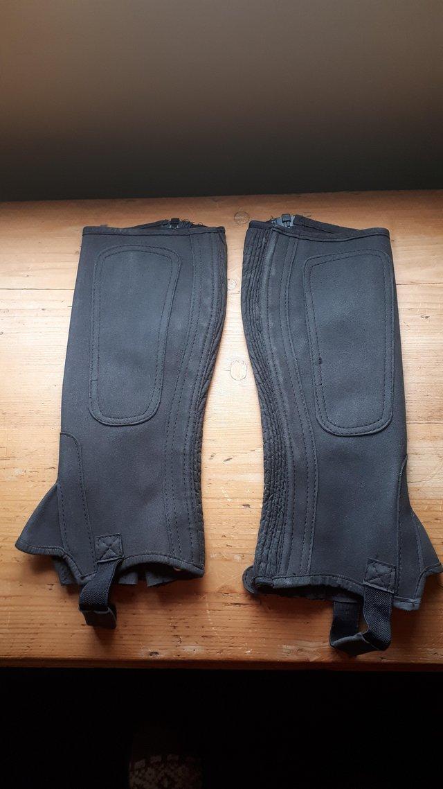 Preview of the first image of Shires Black Half Chaps - Medium.