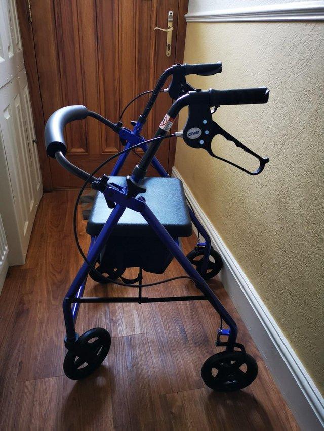 Preview of the first image of 4 Wheeled Walker c/w seat and under seat bag.