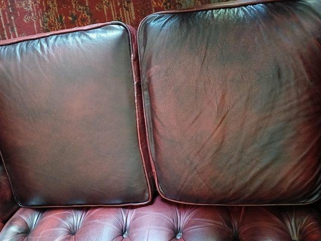 Preview of the first image of Small 2 seater chesterfield sofa in red leather.