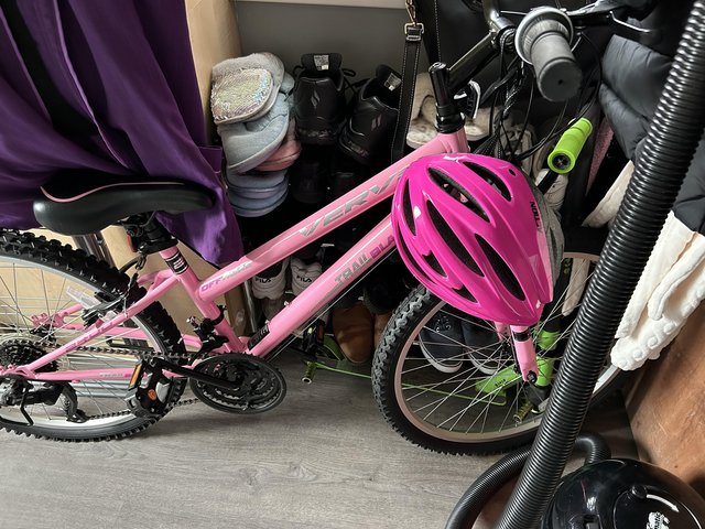 Preview of the first image of Girls 24” bike with pink helmet.