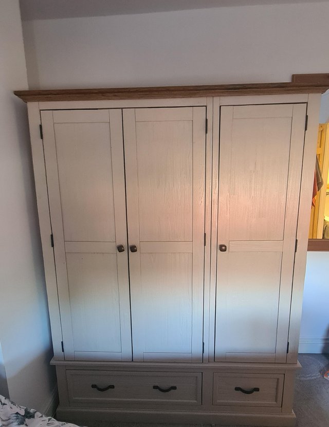 Preview of the first image of Oak Furniture land three door wardrobe.