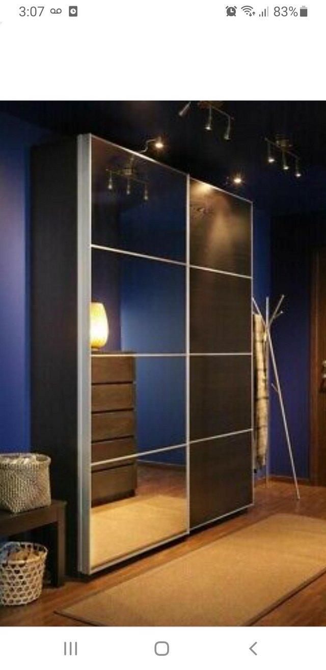 Preview of the first image of Ikea pax wardrobe with sliding doors black colour.