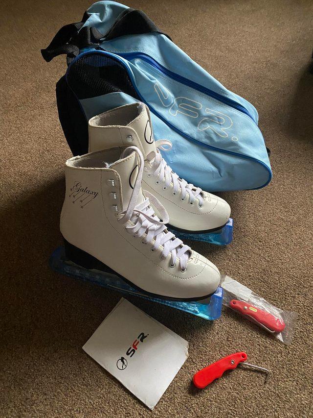 Preview of the first image of Size 7 white ice-skates with accessories.