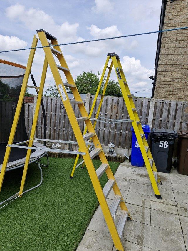 Preview of the first image of Yellow fibre glass tall ladders.