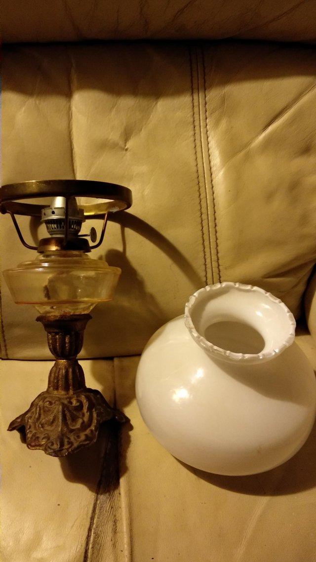 Preview of the first image of VINTAGE OIL LAMP WITH CAST IRON BASE.