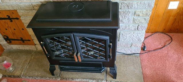 Image 3 of Black iron traditional looking electric fireplace with wood