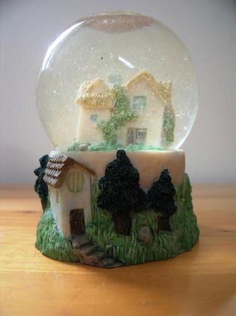 Image 3 of 2 ornaments: sand filled light bulb shape and glitter globe