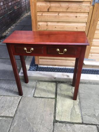 Image 1 of An attractive four legged hall table with two drawers.