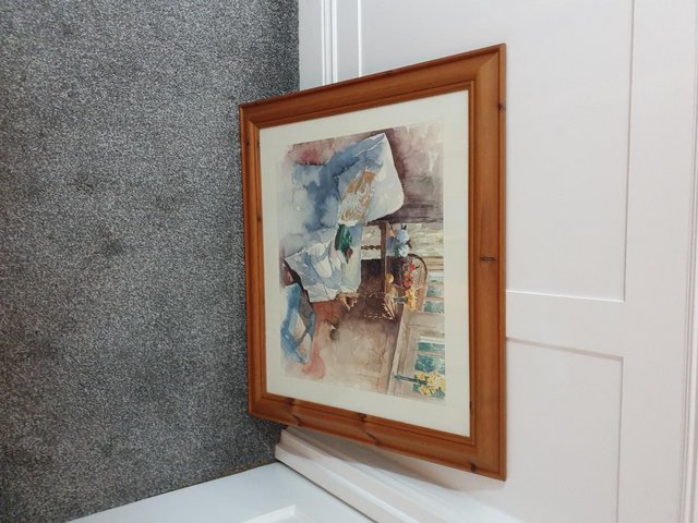 Preview of the first image of Armchair in window picture in wooden frame.