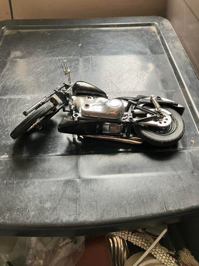 Preview of the first image of Model of black motorcycle with stand.