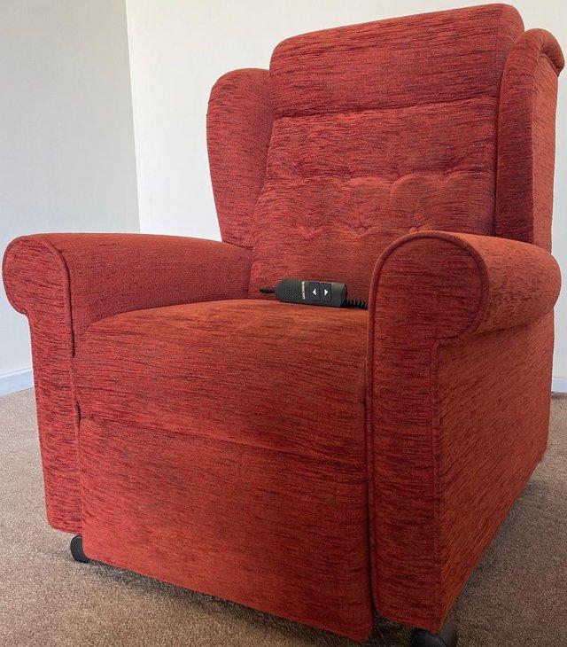 Preview of the first image of LUXURY ELECTRIC RISER RECLINER TERRACOTTA CHAIR CAN DELIVER.