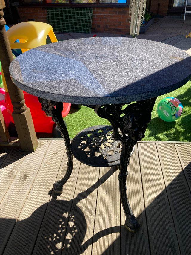 Preview of the first image of Cast iron table with Granite top.