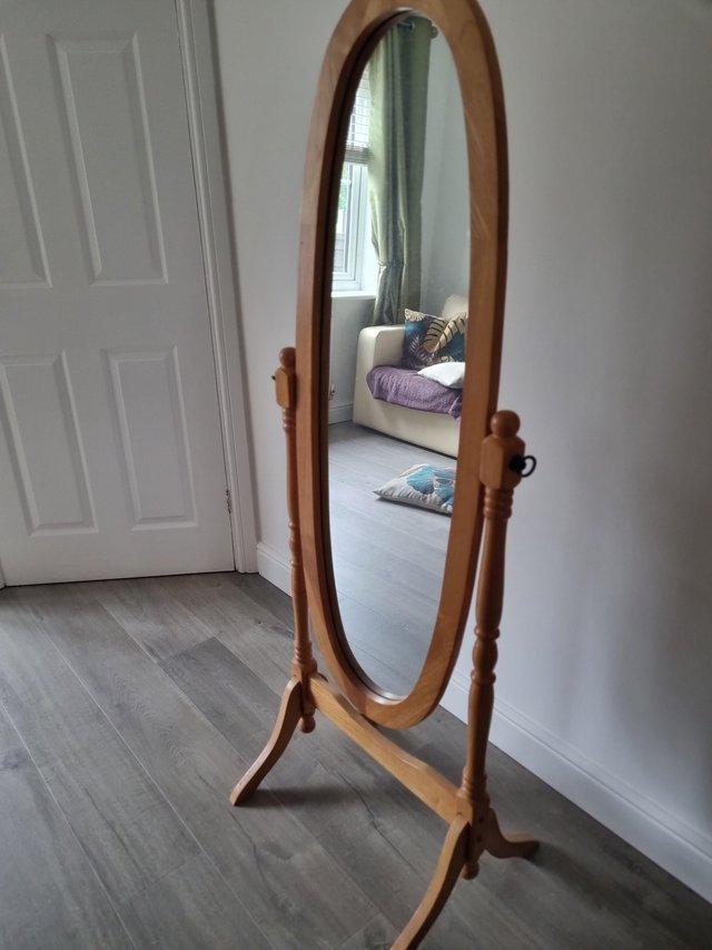 Preview of the first image of Free standing tilting light oak mirror.