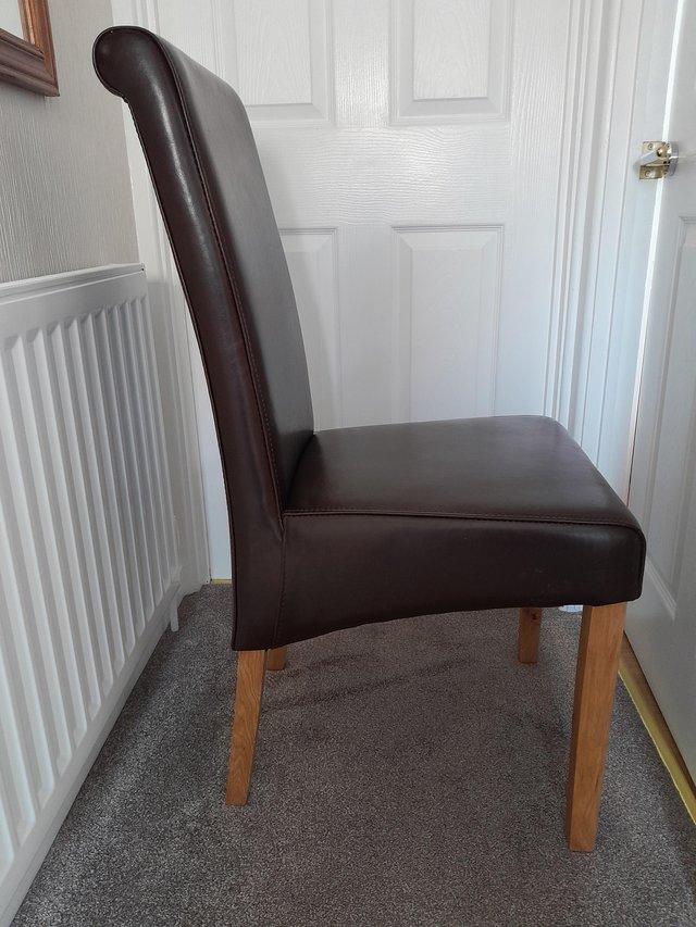 Preview of the first image of Oakfurnitureland brown leather dining room chairs as new.