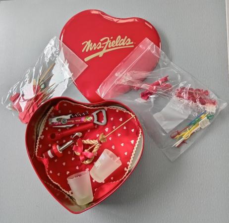 Image 1 of Red Heart Shaped Tin with Party Accessories.