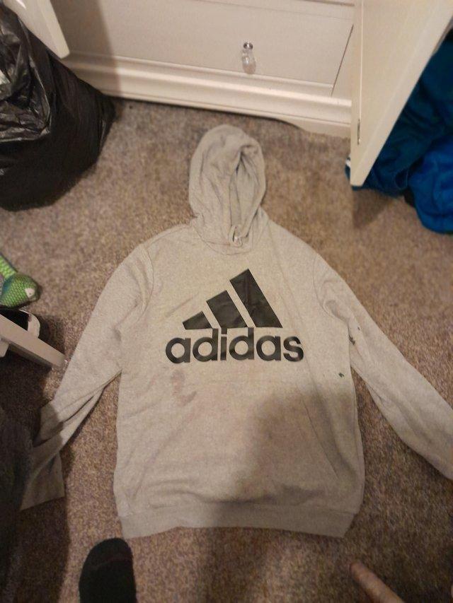 Preview of the first image of A grey and black adidas hoodie large mens.