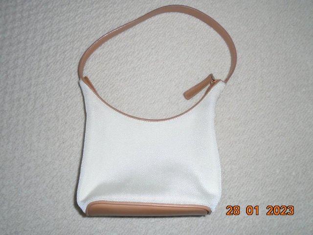 Preview of the first image of Nine West cream and tan trim zipped handbag.