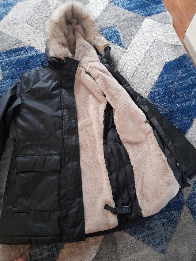 Preview of the first image of Ladies fur lined black parka. From marks & spencers.
