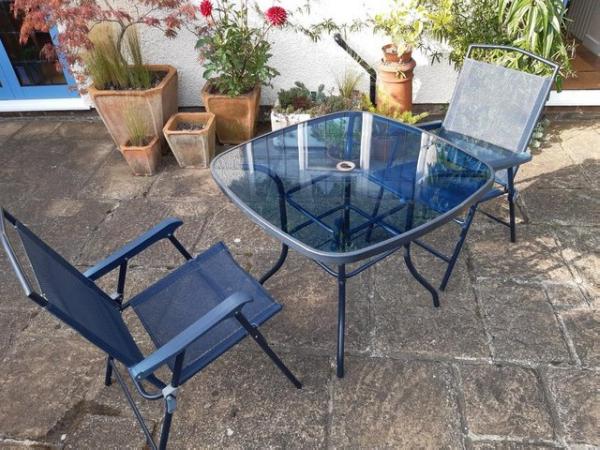 Image 1 of Glass Patio Table and 2 Folding Chairs