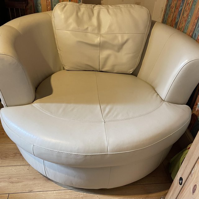 Preview of the first image of Cream leather rotating loveseat.