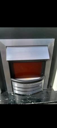 Image 2 of Next Chrome Electric Fire and Surround.