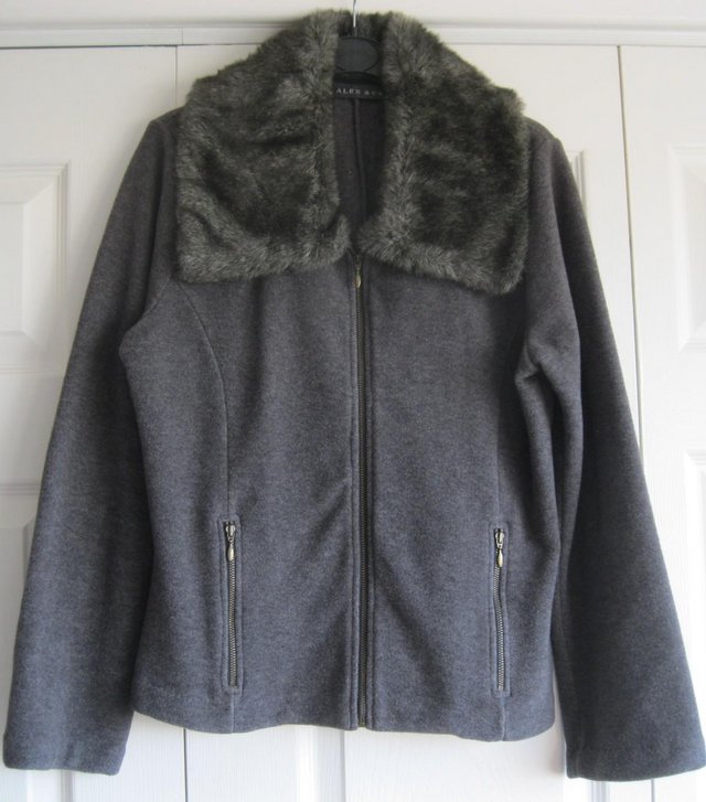 Preview of the first image of Dark grey fleecy Jacket with fur collar, size 12.