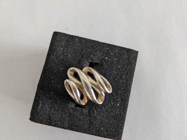 Preview of the first image of Sterling silver twisted ribbon style ring.