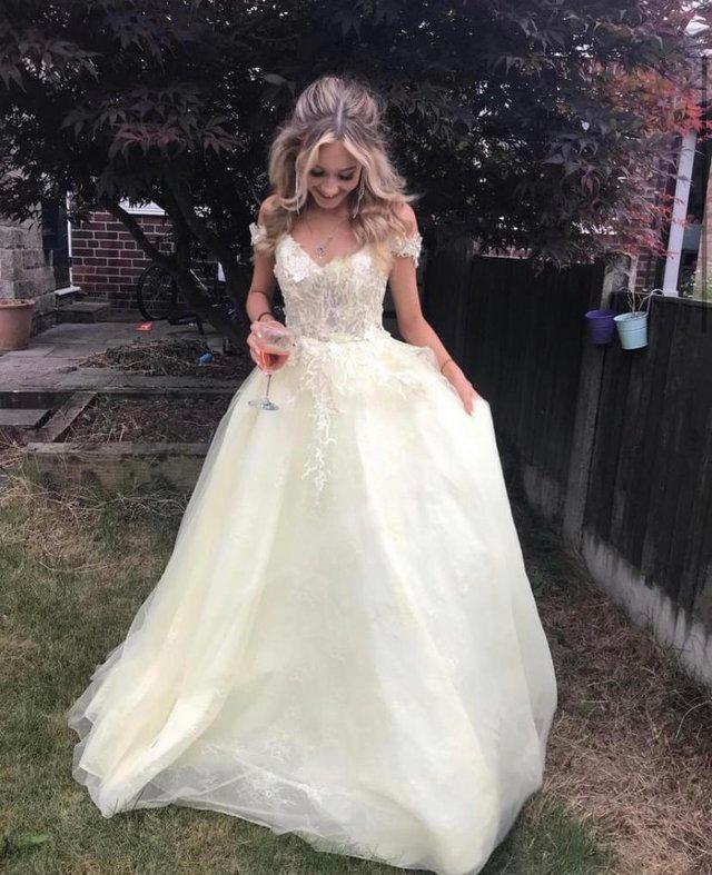 Preview of the first image of Pale yellow Tiffany’s prom dress.