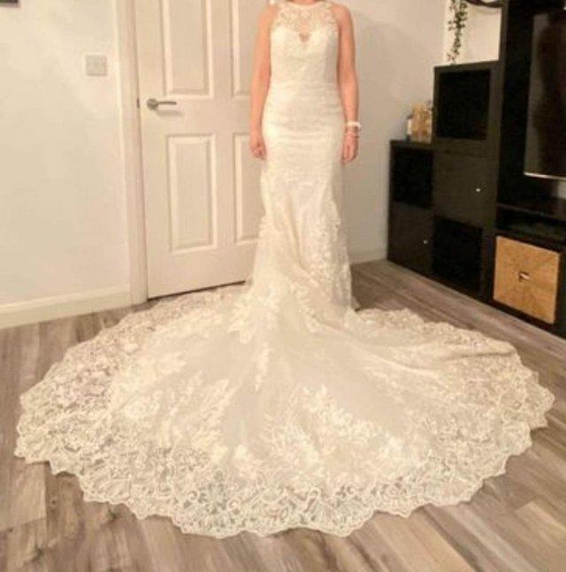 Preview of the first image of Christina Wu style 15620 ivory lace slim flare wedding dress.