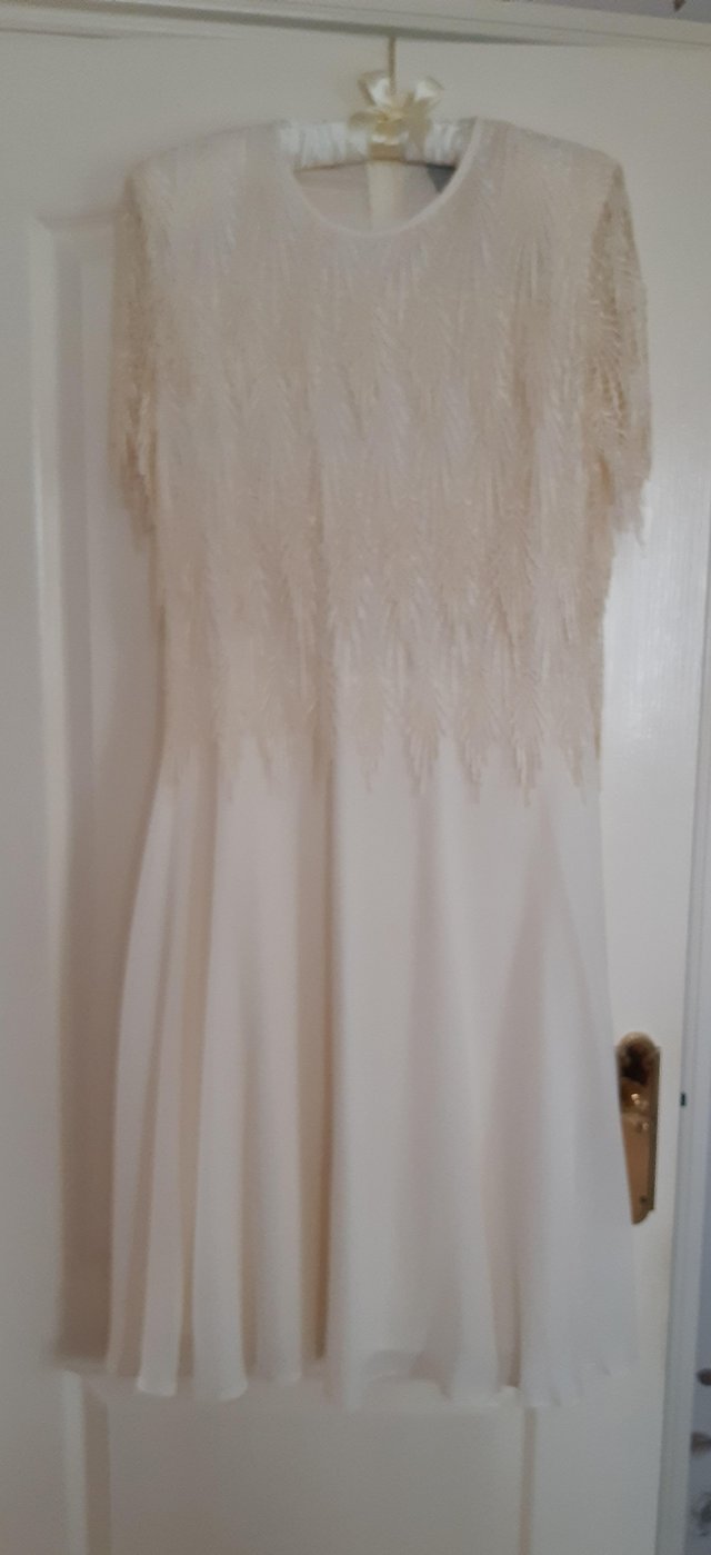 Preview of the first image of Wedding dress cream silky fabric.
