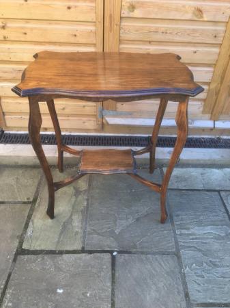 Image 2 of An attractive wooden table with nicely shaped top and legs.