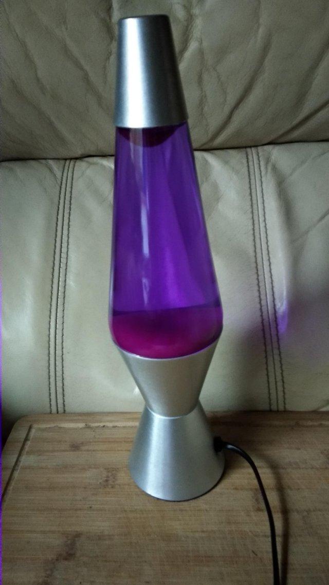 Preview of the first image of ROCKET LAVA LAMP RED WAX IN PURPLE FLUID.