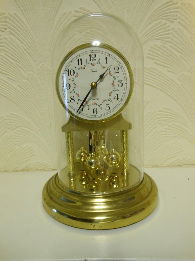 Preview of the first image of Anniversary clock.- Polished brass finish with acrylic dome.