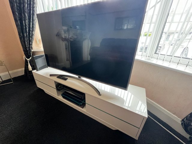 Preview of the first image of Beautiful white Tv stand with 4 touch drawers and LED Lighti.
