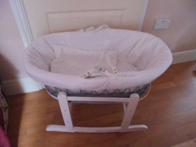 Preview of the first image of Grey wicker moses basket with white rocking stand.
