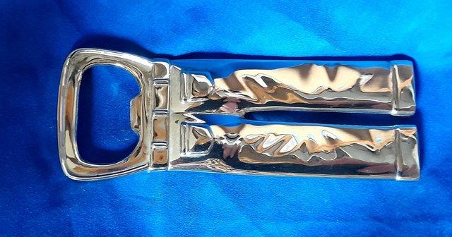 Preview of the first image of CHROME BOTTLE OPENER -TROUSER SHAPE 10 cm.