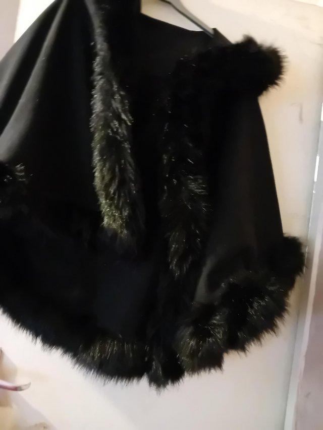 Preview of the first image of Ladies cape coat with hood.  Faux fur trim.