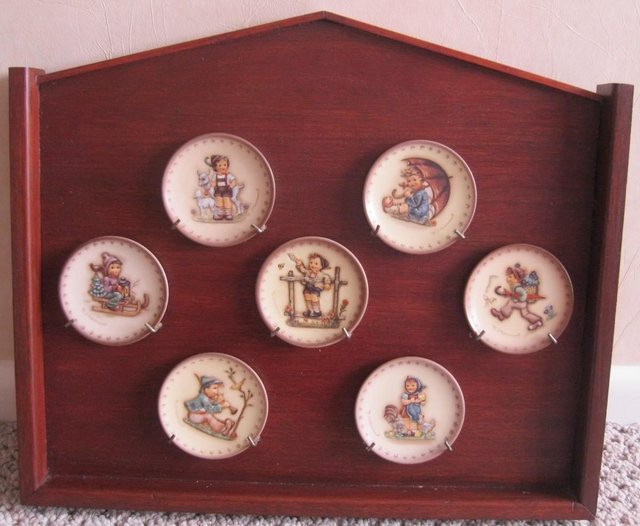 Preview of the first image of Seven small M J Hummel Plates and display case.